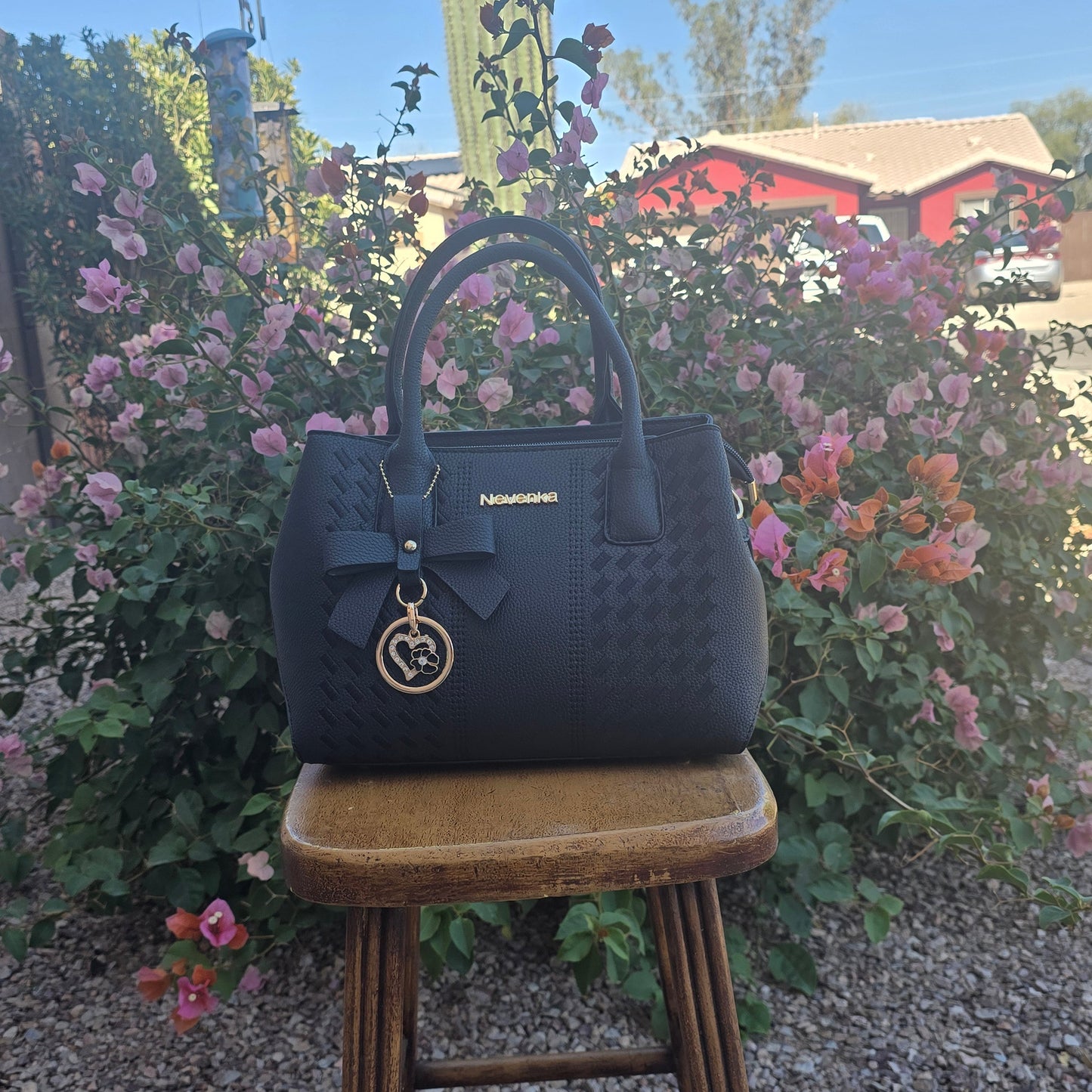 Black handbag with a gold charm