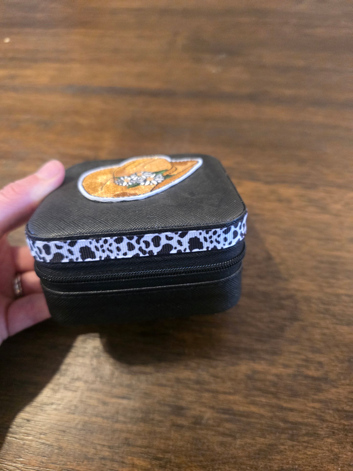 Small black jewelry box with cow print band 